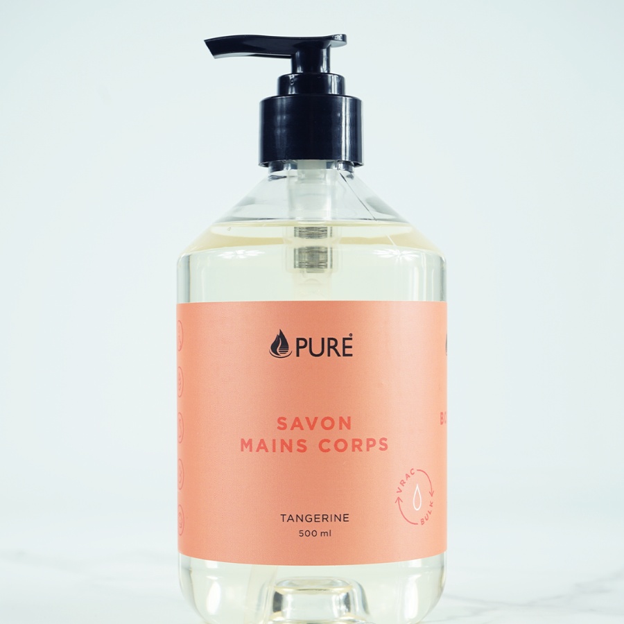 Pure brand organic and biodegradable hand and body wash in a clear bottle with orange label.